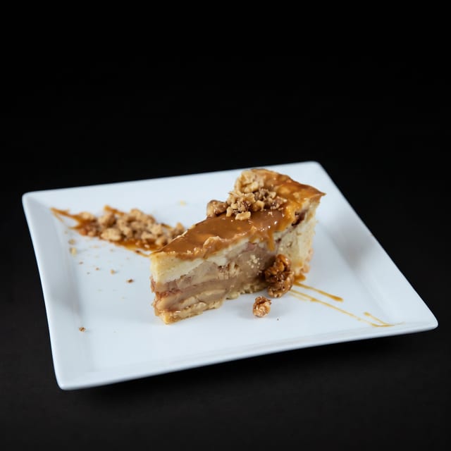 Apple Pie Slice Topped with Caramel Sauce.